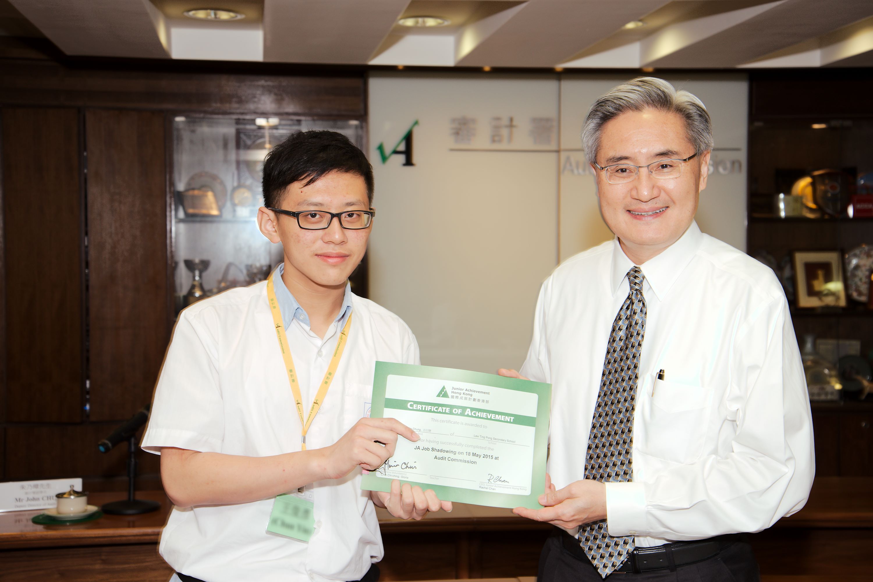 Our Director presenting the certificates of achievement to a student representative from Law Ting Pong Secondary School